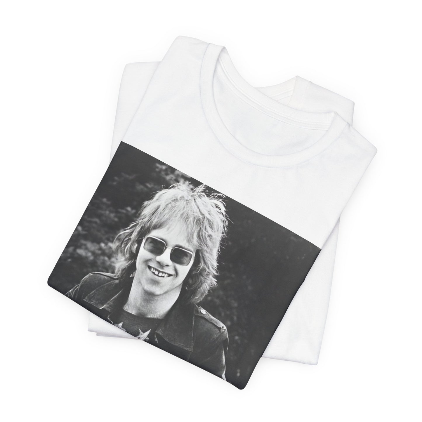 A black graphic t-shirt featuring a 70s black and white monochrome graphic or photo of Elton John.