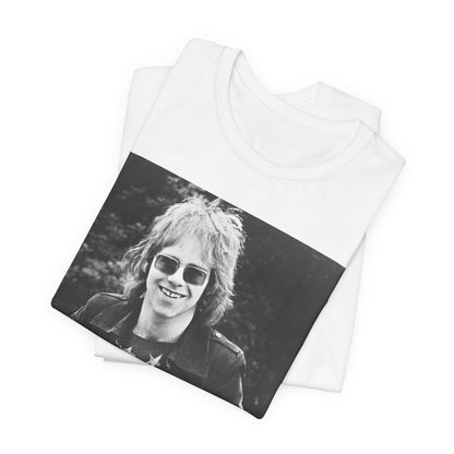 A black graphic t-shirt featuring a 70s black and white monochrome graphic or photo of Elton John.