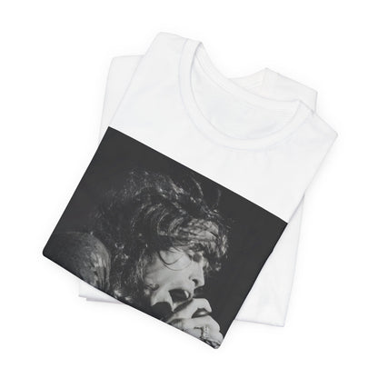 A black graphic t-shirt featuring a retro 70s-style illustration or photo of Aerosmith, designed to evoke their 'On Tour' presence, possibly with band members on stage or tour bus imagery.