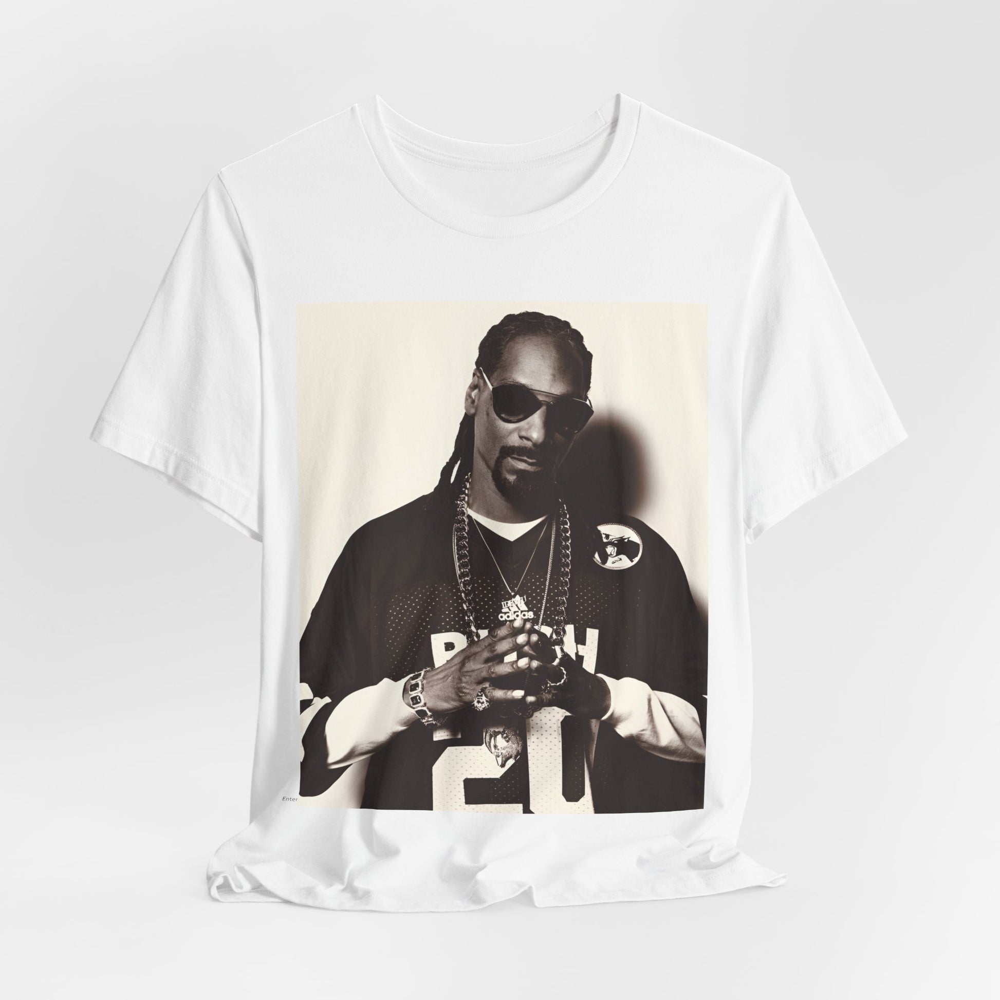 A black graphic t-shirt featuring a black and white, monochrome graphic or photo of Snoop Dogg in an OG style.