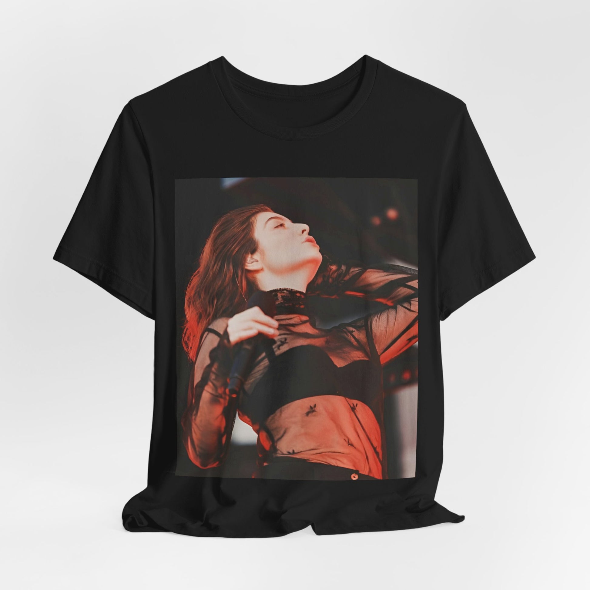 A black graphic t-shirt featuring a graphic of Lorde emphasizing raw emotion.