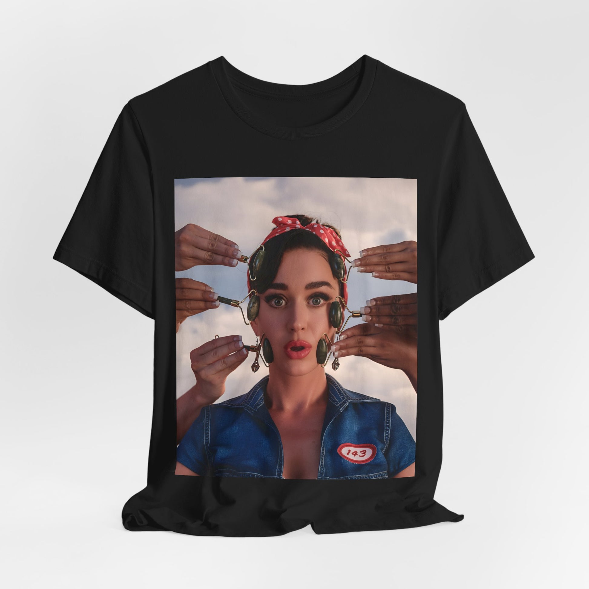 A black graphic t-shirt featuring a modern pop essential graphic of Katy Perry.