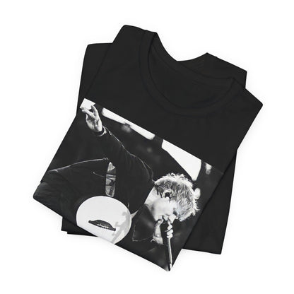 A black graphic t-shirt featuring a vintage graphic of Ed Sheeran performing live.