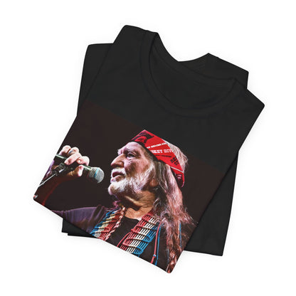 A black graphic t-shirt featuring a graphic of Willie Nelson with his iconic long hair and bandana.