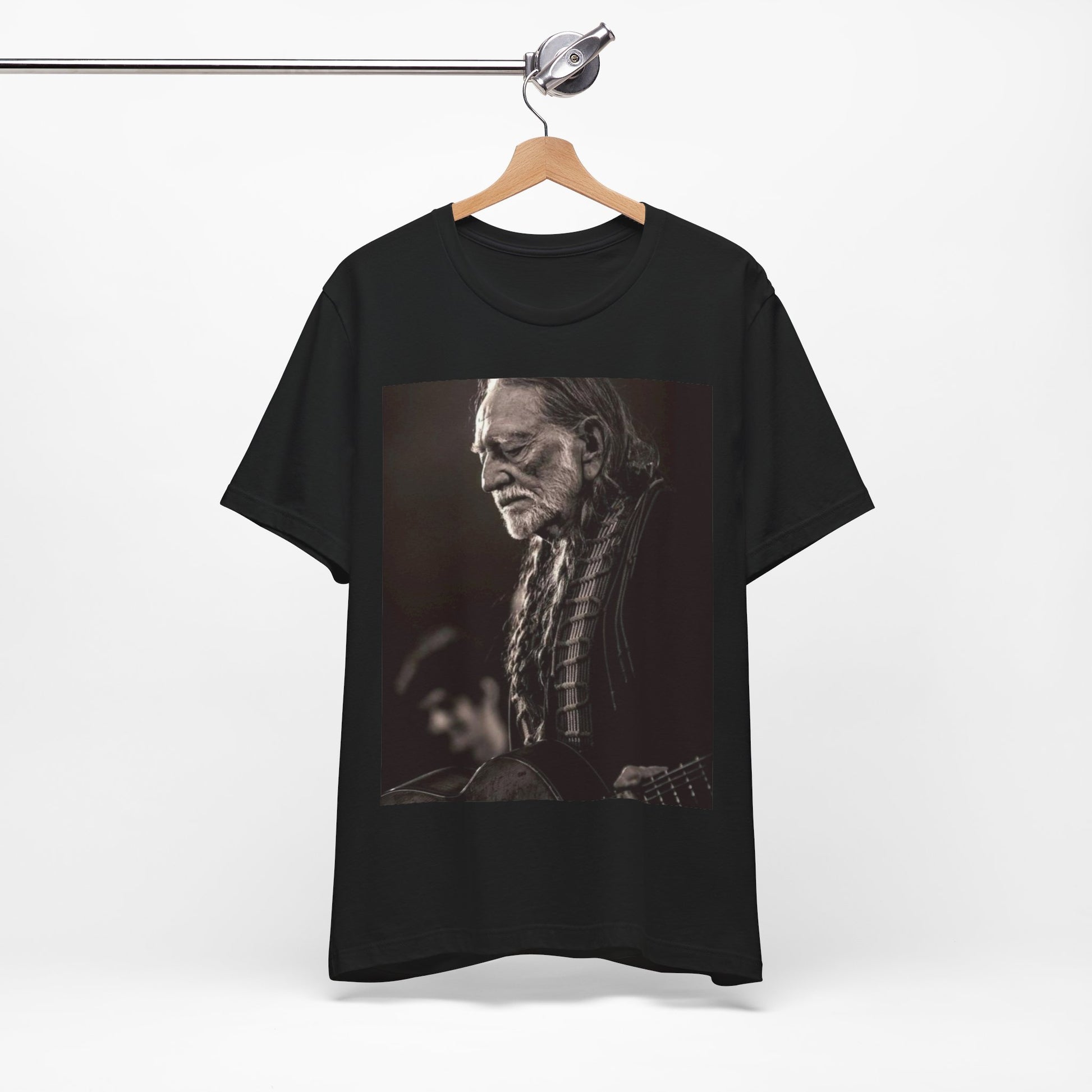 A black graphic t-shirt featuring a vintage country legend graphic of Willie Nelson.