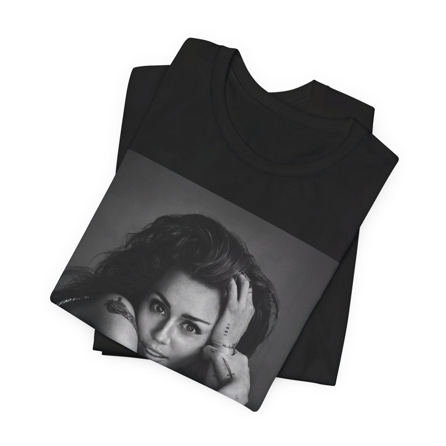 A black graphic t-shirt featuring a black and white portrait graphic of Miley Cyrus.