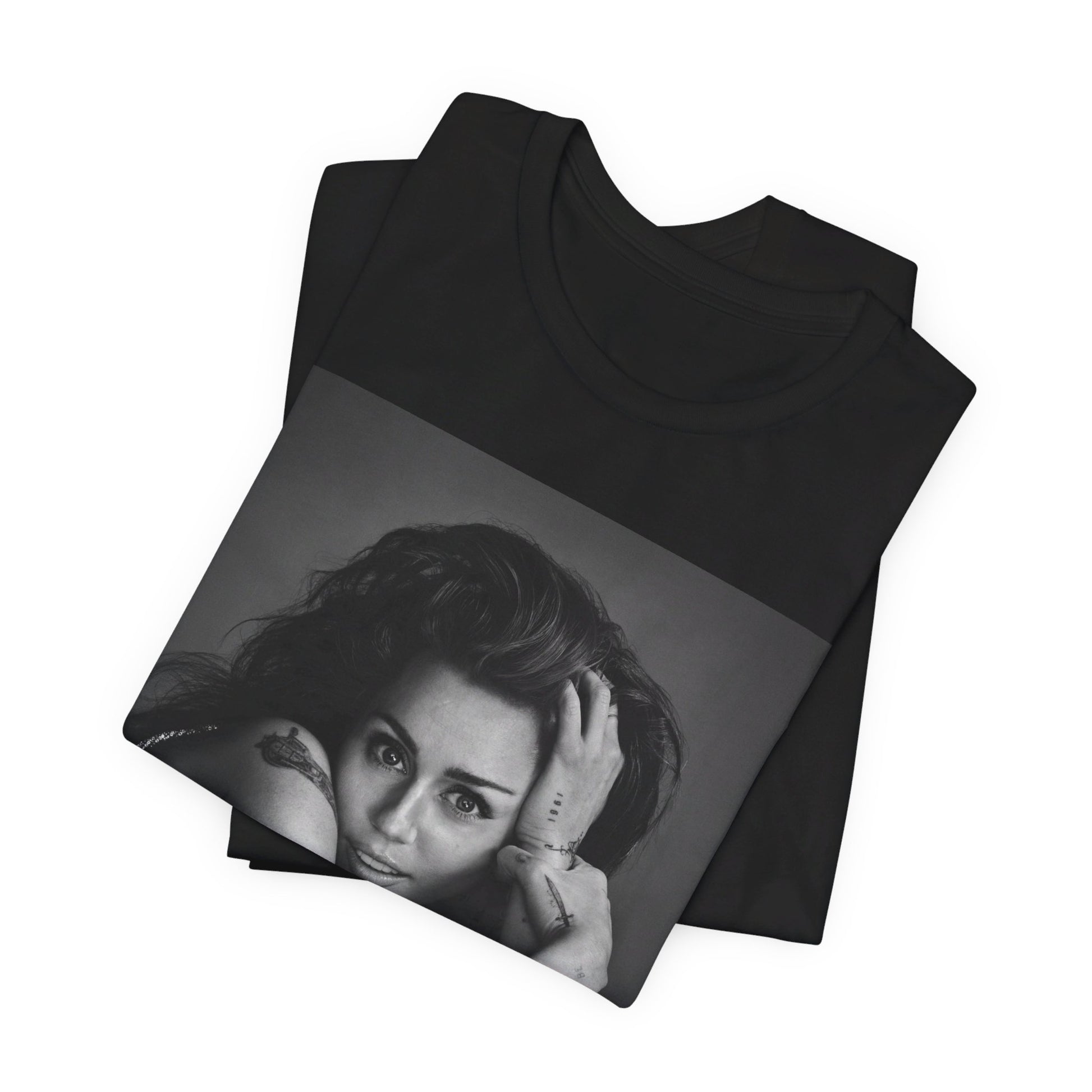 A black graphic t-shirt featuring a black and white portrait graphic of Miley Cyrus.