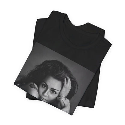 A black graphic t-shirt featuring a black and white portrait graphic of Miley Cyrus.
