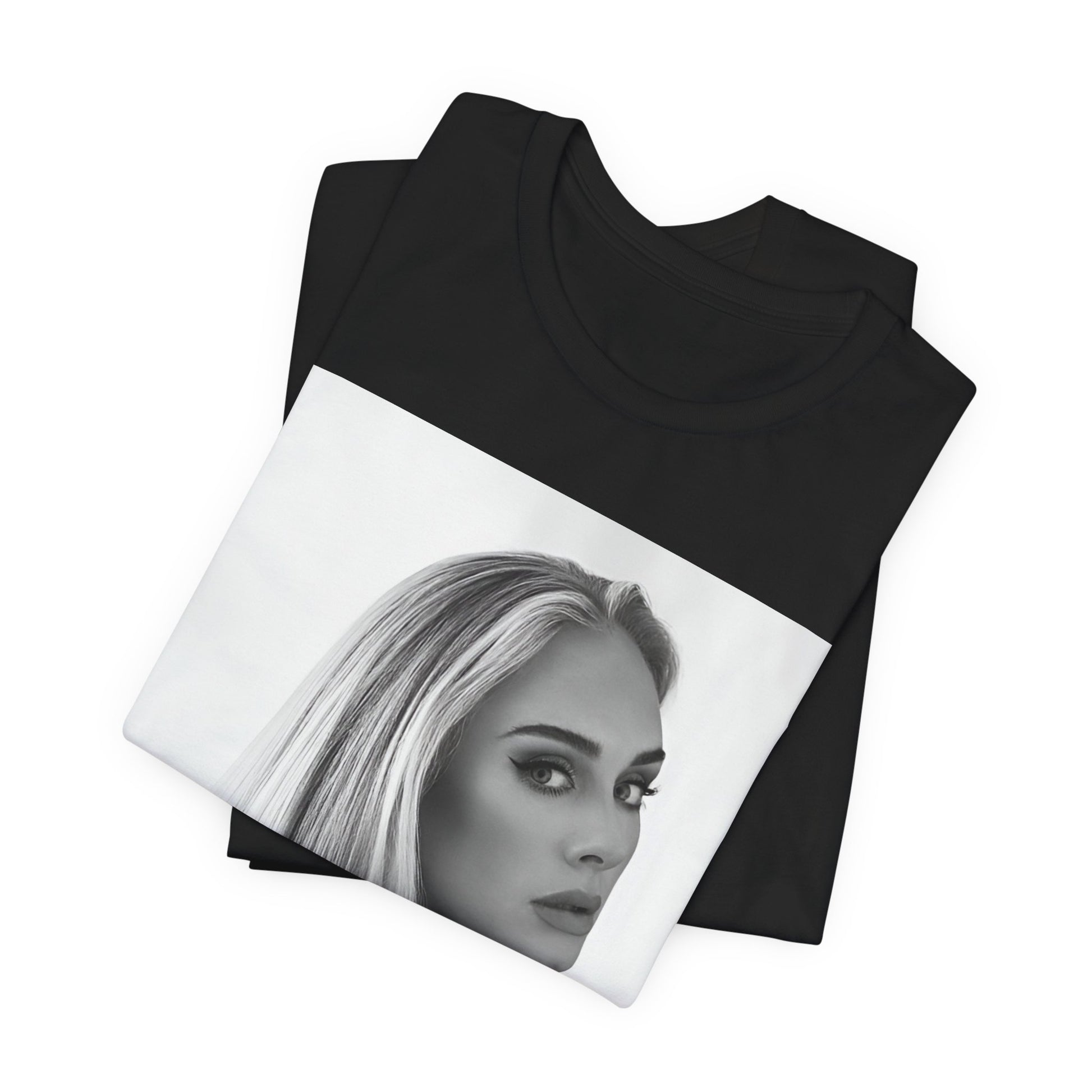 A black graphic t-shirt featuring a black and white, monochromatic portrait of Adele, showing her with a serene or thoughtful expression.