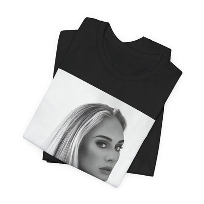 A black graphic t-shirt featuring a black and white, monochromatic portrait of Adele, showing her with a serene or thoughtful expression.