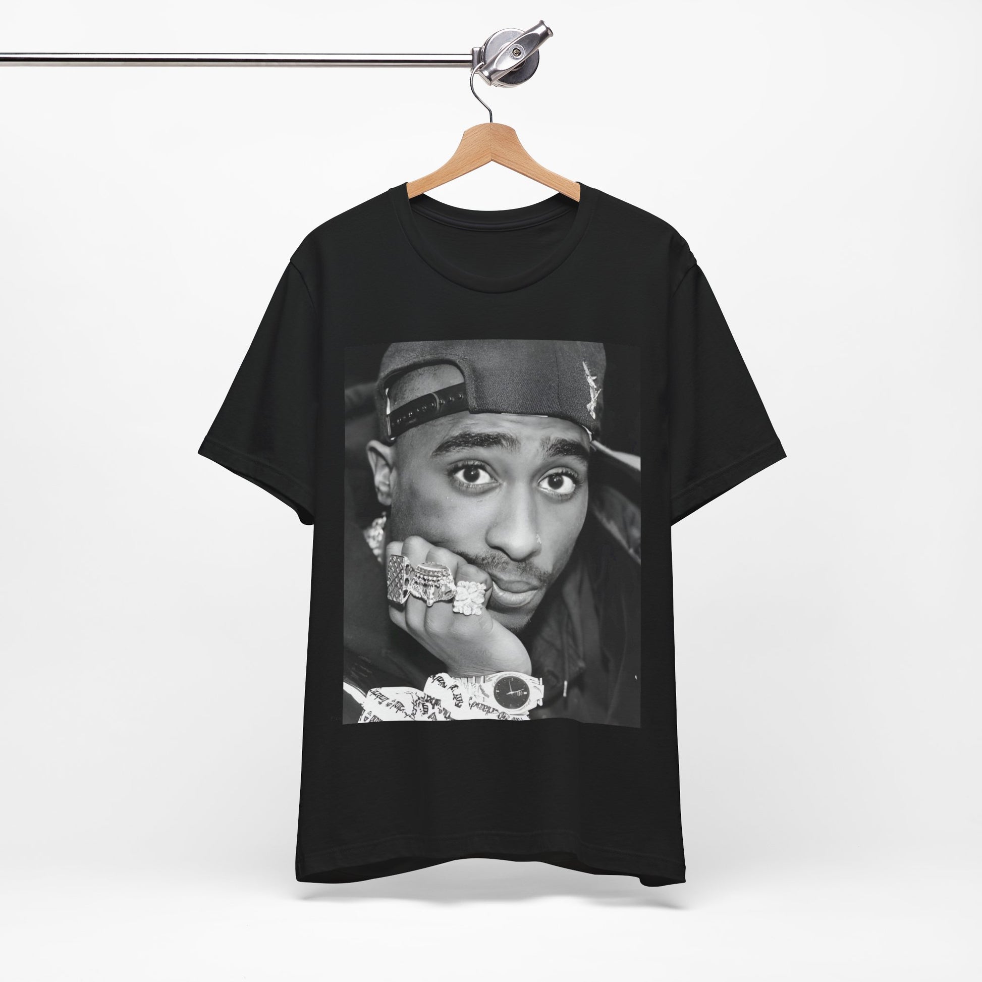 A black graphic t-shirt featuring a bold graphic of Tupac as a rap superstar.