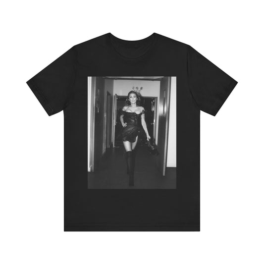 A black graphic t-shirt featuring a black and white graphic of Miley Cyrus in a cool pop rock style.