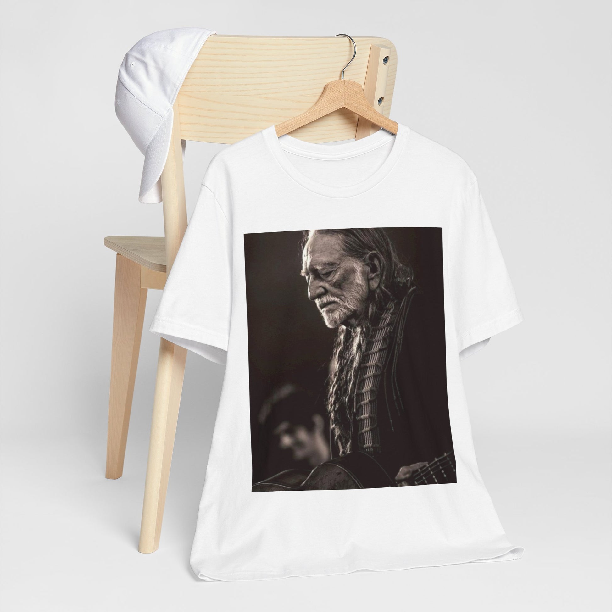 A black graphic t-shirt featuring a vintage country legend graphic of Willie Nelson.