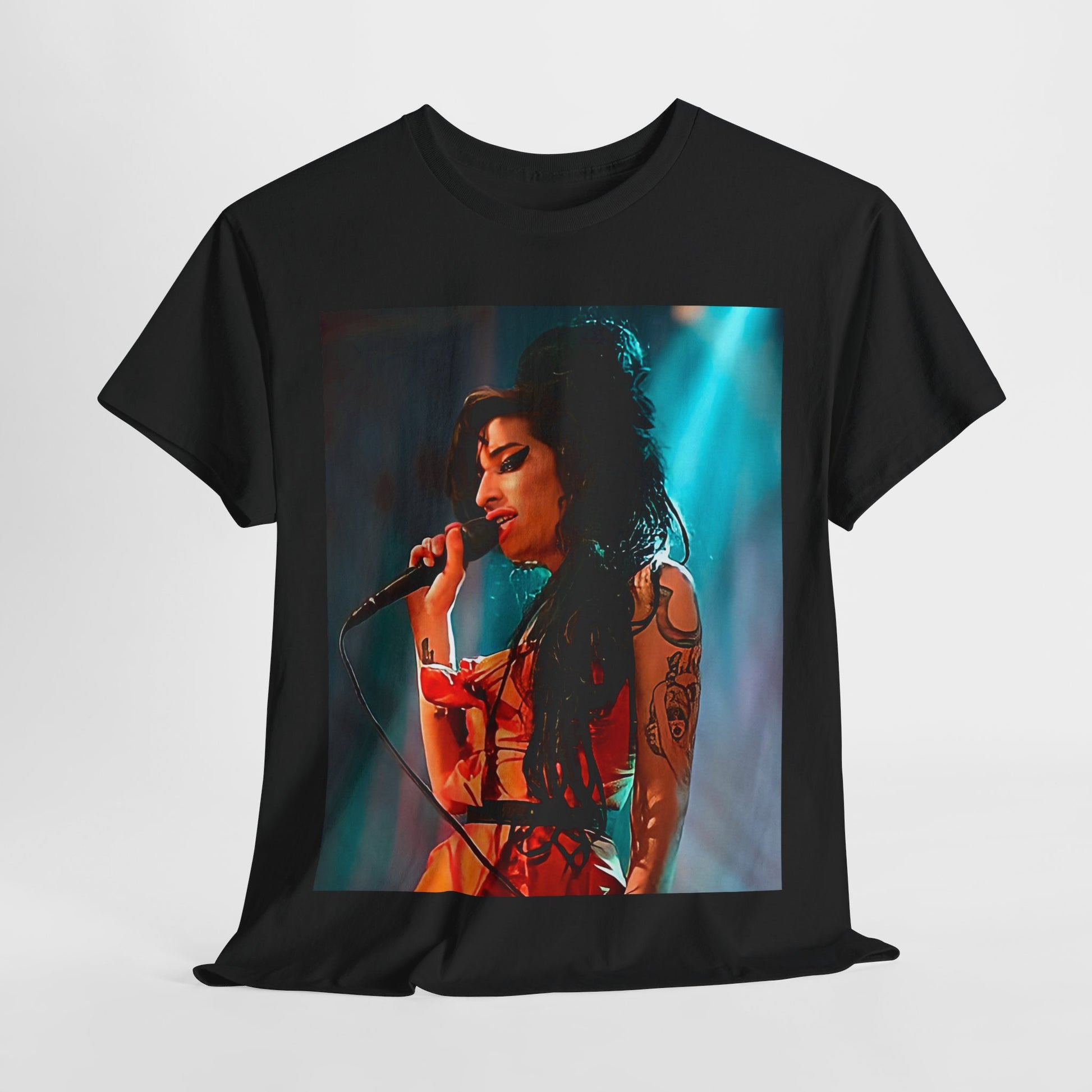 A black graphic t-shirt featuring a photo of Amy Winehouse performing live on stage in 2007, with her signature beehive and expressive singing.