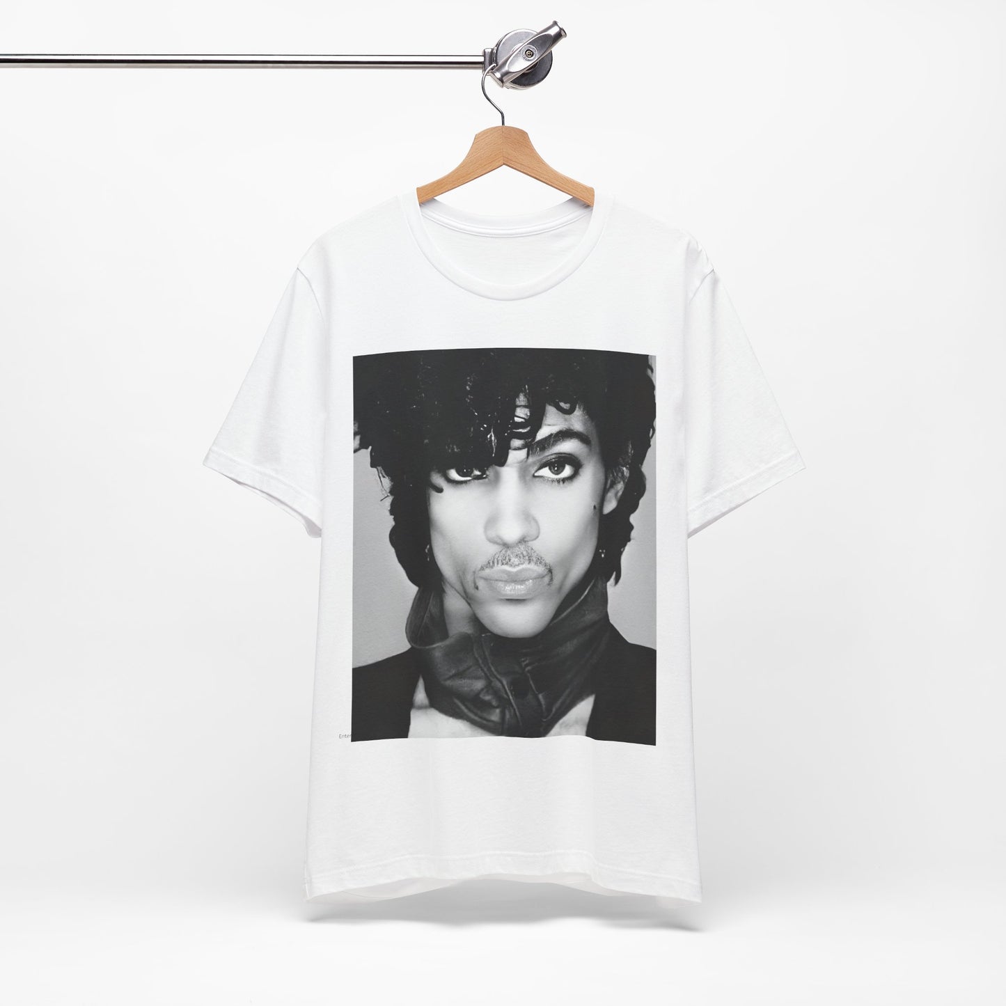 A black graphic t-shirt featuring a black and white photo portrait of Prince.