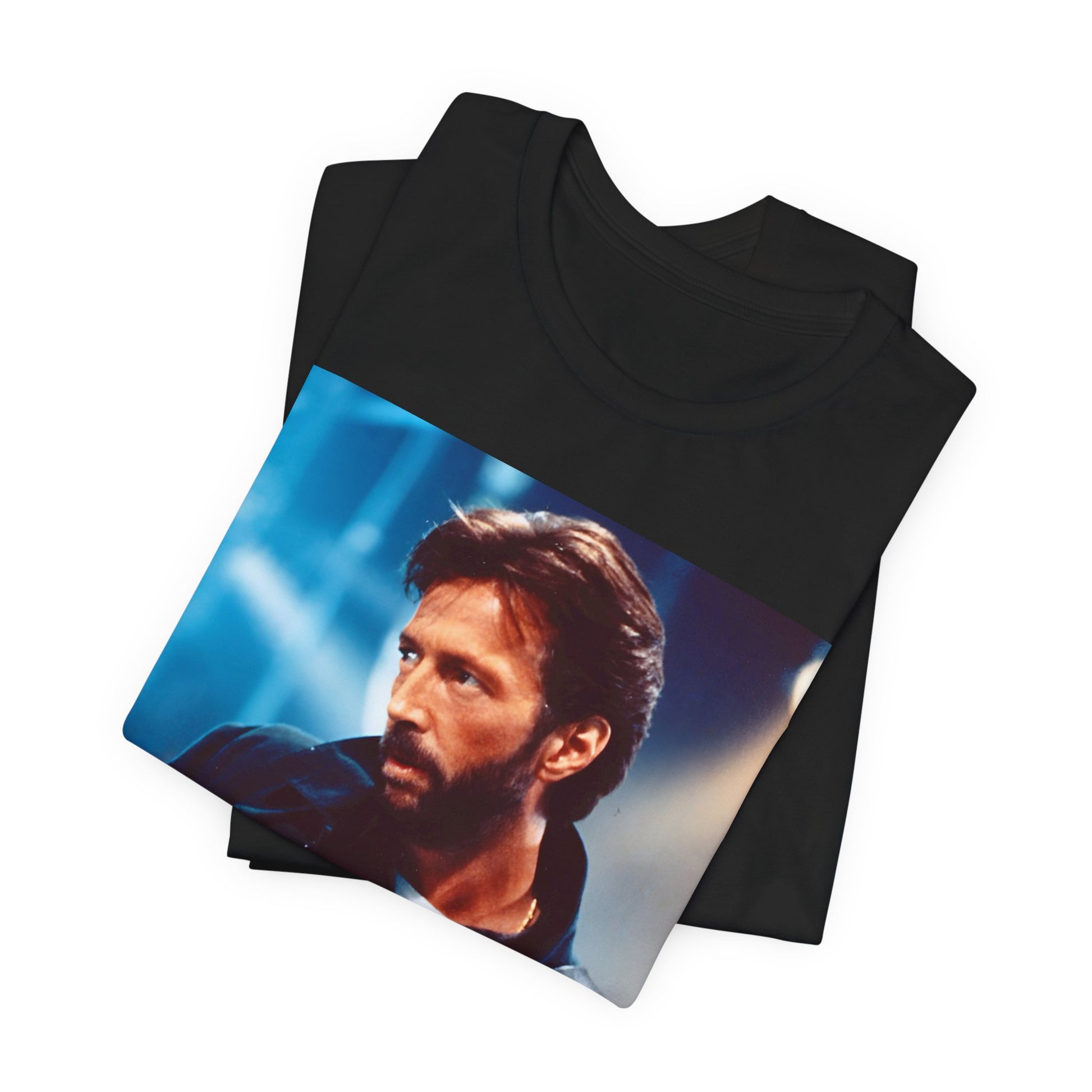 A black graphic t-shirt featuring a retro graphic or photo of Eric Clapton performing live on stage.