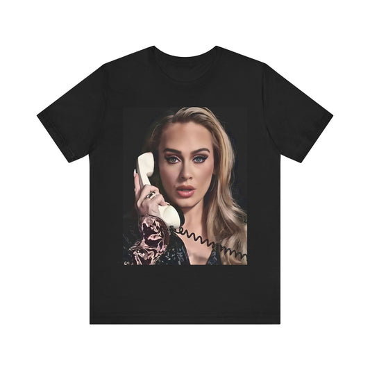 A black graphic t-shirt featuring a black and white candid photo of Adele with a phone to her ear, showing a thoughtful or emotional expression.