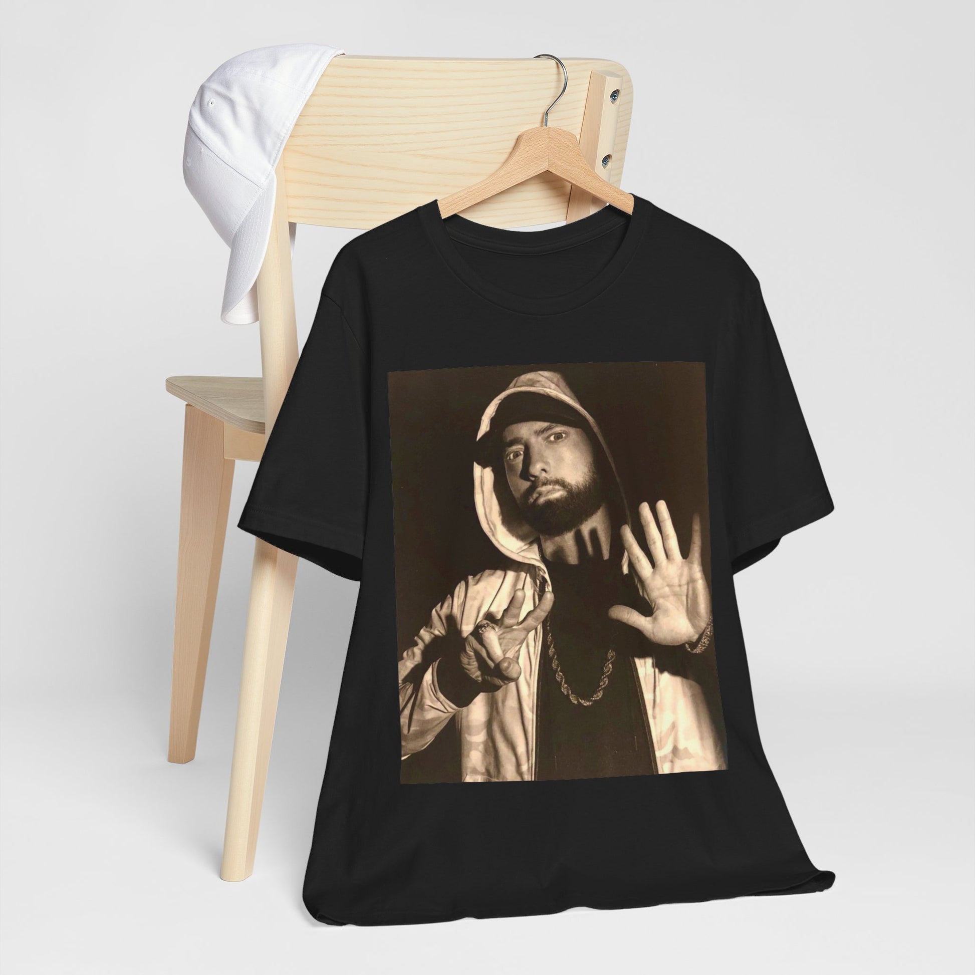 A black graphic t-shirt featuring a graphic of Eminem as an authentic underground rap icon.