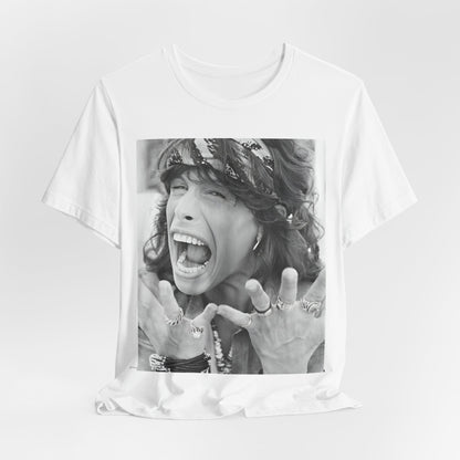 A black graphic t-shirt featuring a candid, dynamic photo of Aerosmith band members on tour in the 1970s, possibly showing action or interaction on stage or backstage.