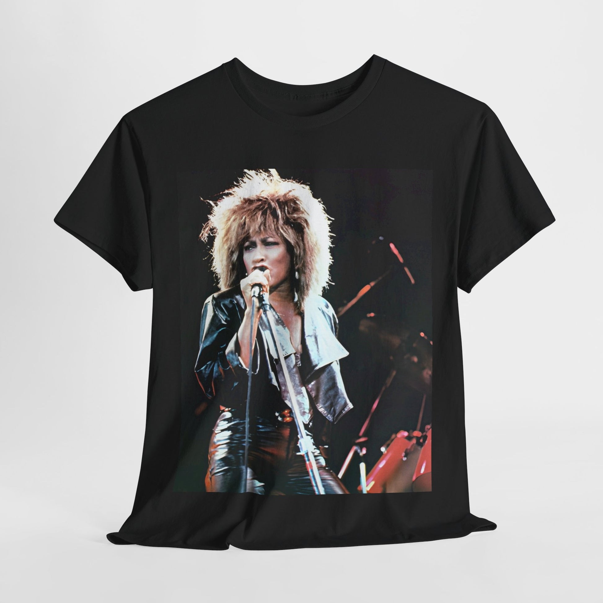 A black graphic t-shirt featuring a 90s graphic or photo of Tina Turner performing live on stage.