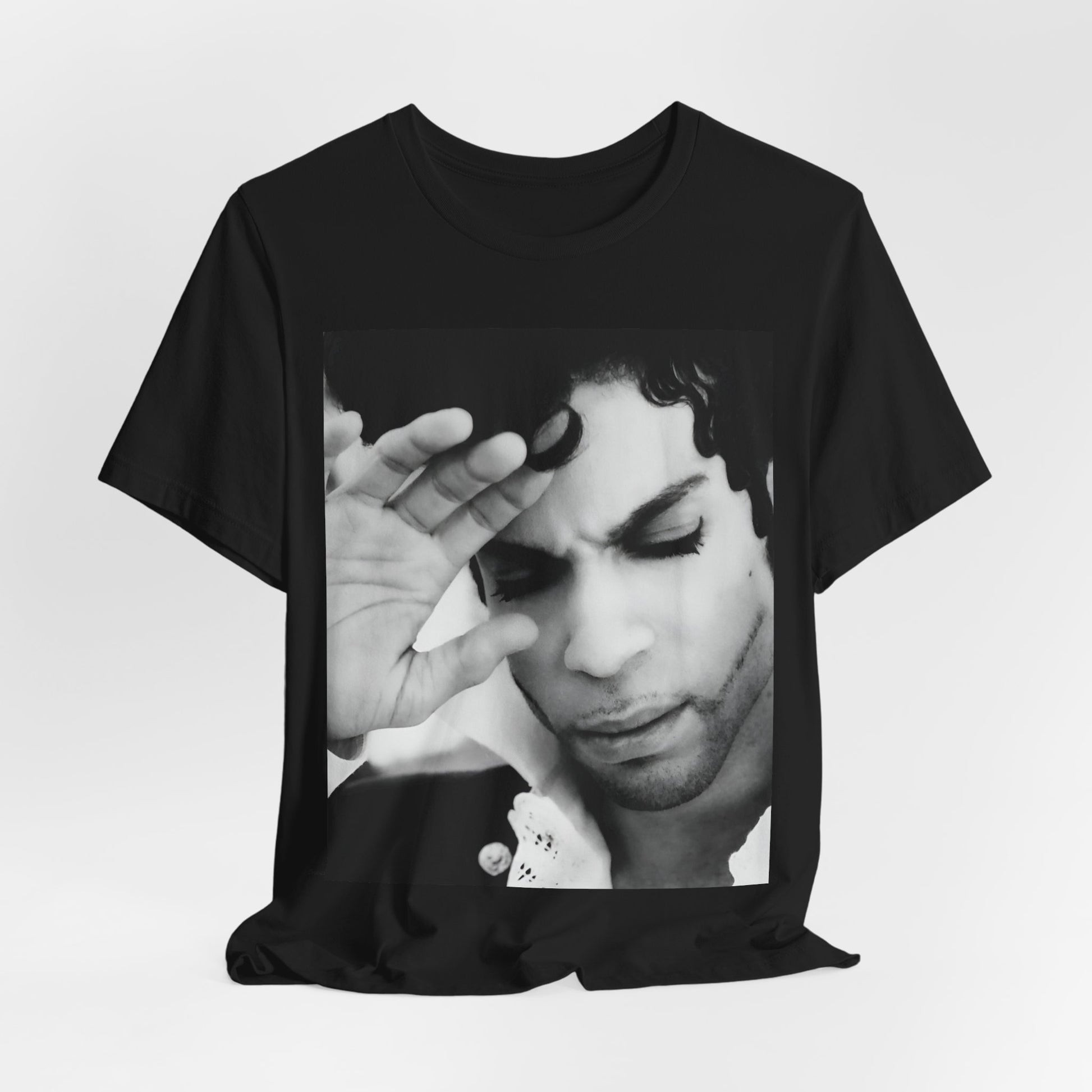 A black graphic t-shirt featuring a black and white graphic or photo portrait of Prince.