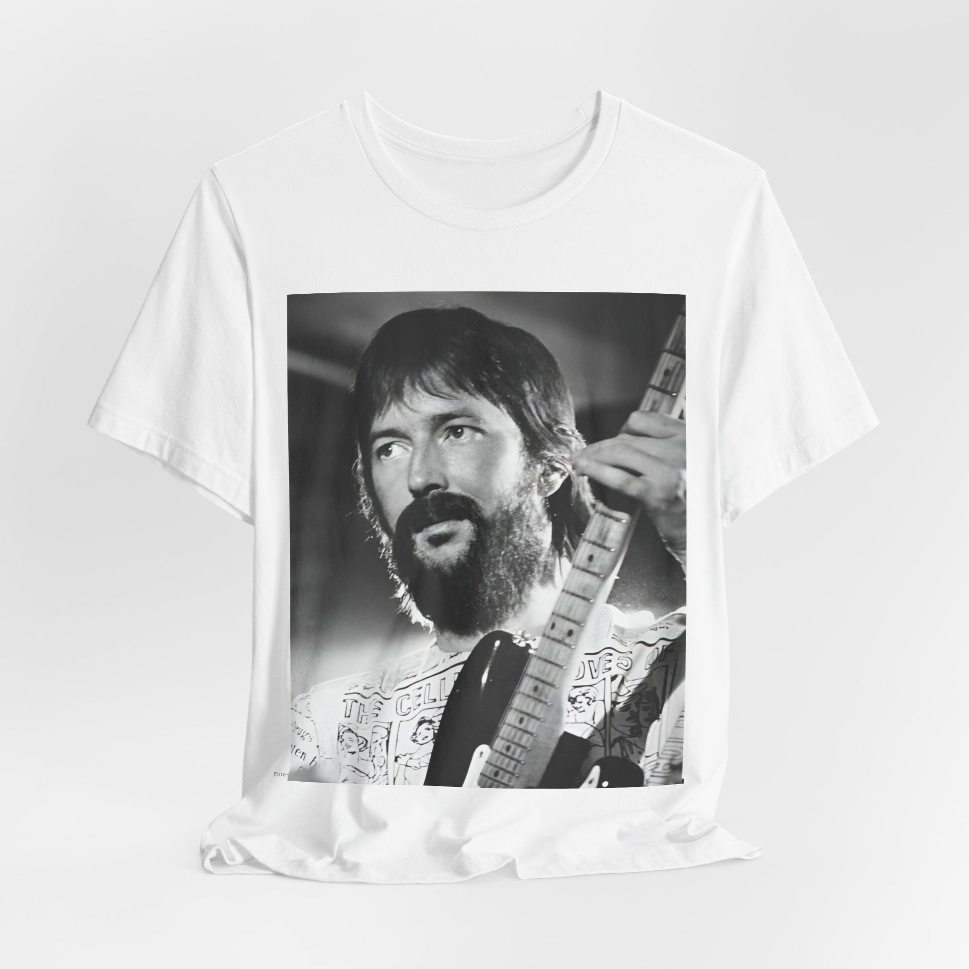 A black graphic t-shirt featuring a graphic of Eric Clapton as an authentic guitar god.