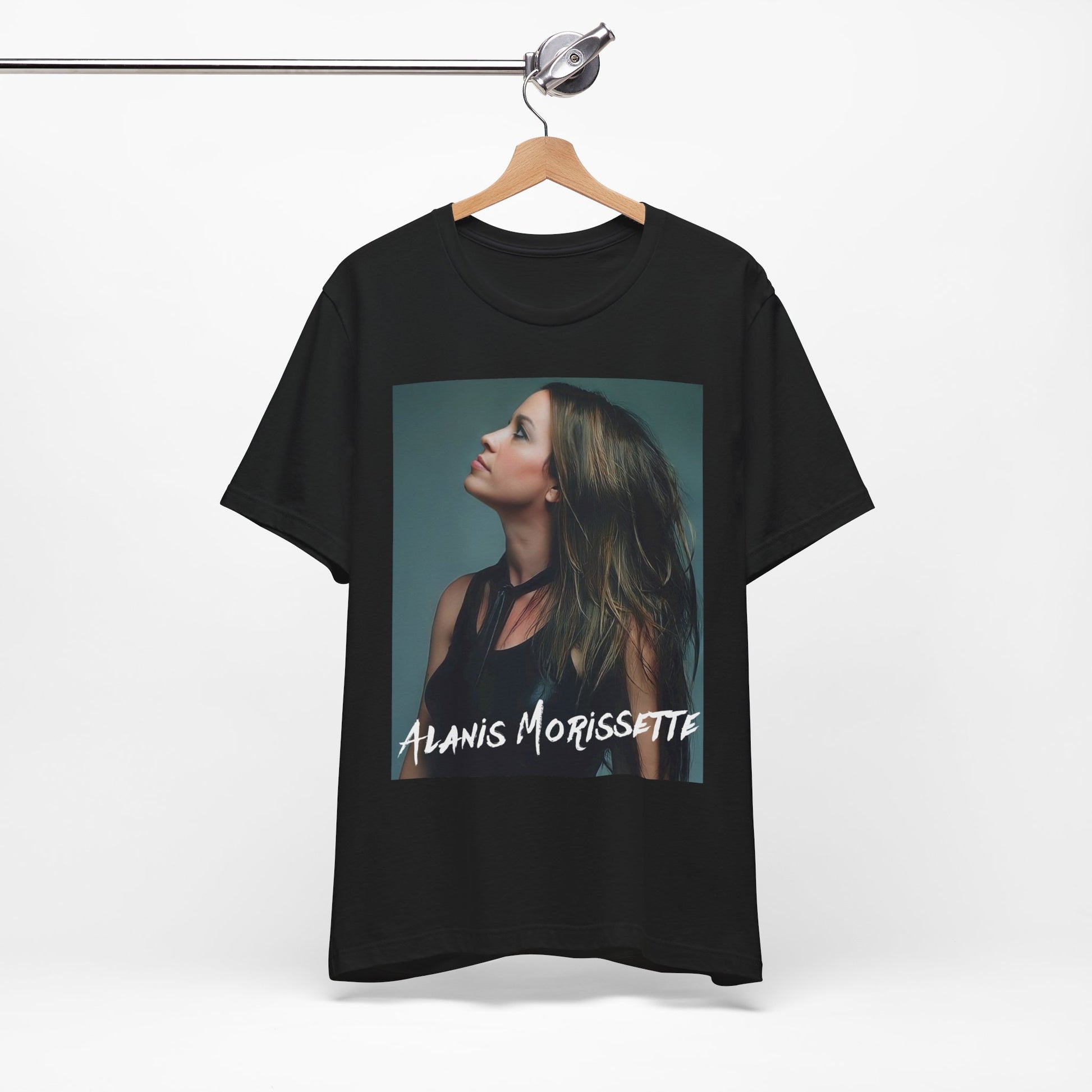 A black graphic t-shirt featuring a retro-style graphic of Alanis Morissette, possibly with her signature or a unique artistic interpretation.