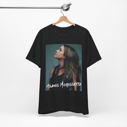 A black graphic t-shirt featuring a retro-style graphic of Alanis Morissette, possibly with her signature or a unique artistic interpretation.