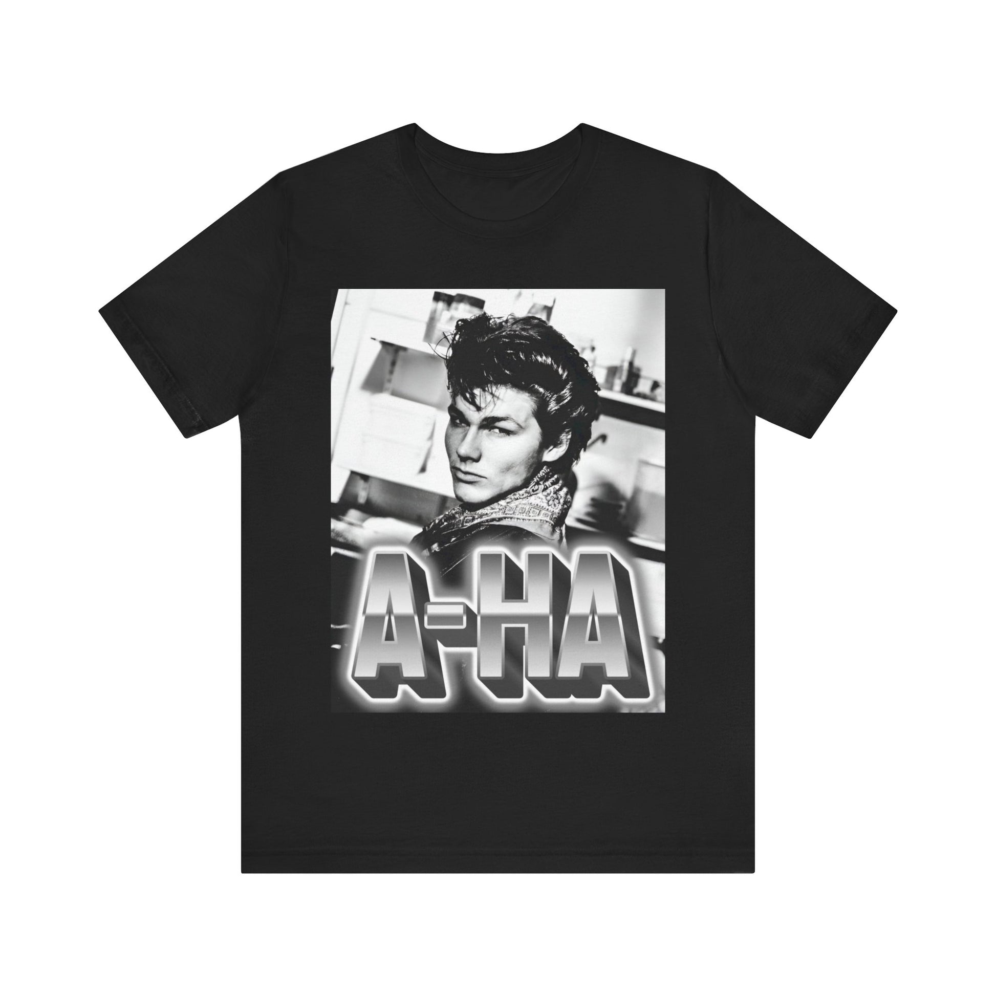 A black graphic t-shirt featuring a retro 1986-style graphic for the band A-HA, possibly with band members in a stylized design.