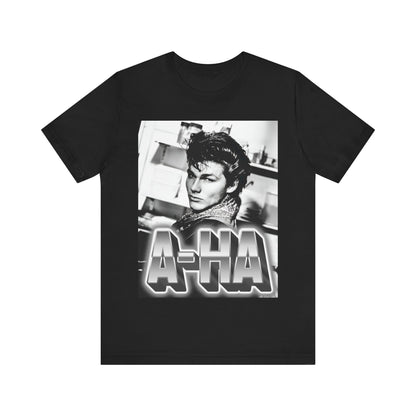 A black graphic t-shirt featuring a retro 1986-style graphic for the band A-HA, possibly with band members in a stylized design.