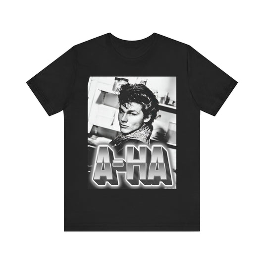 A black graphic t-shirt featuring a retro 1986-style graphic for the band A-HA, possibly with band members in a stylized design.