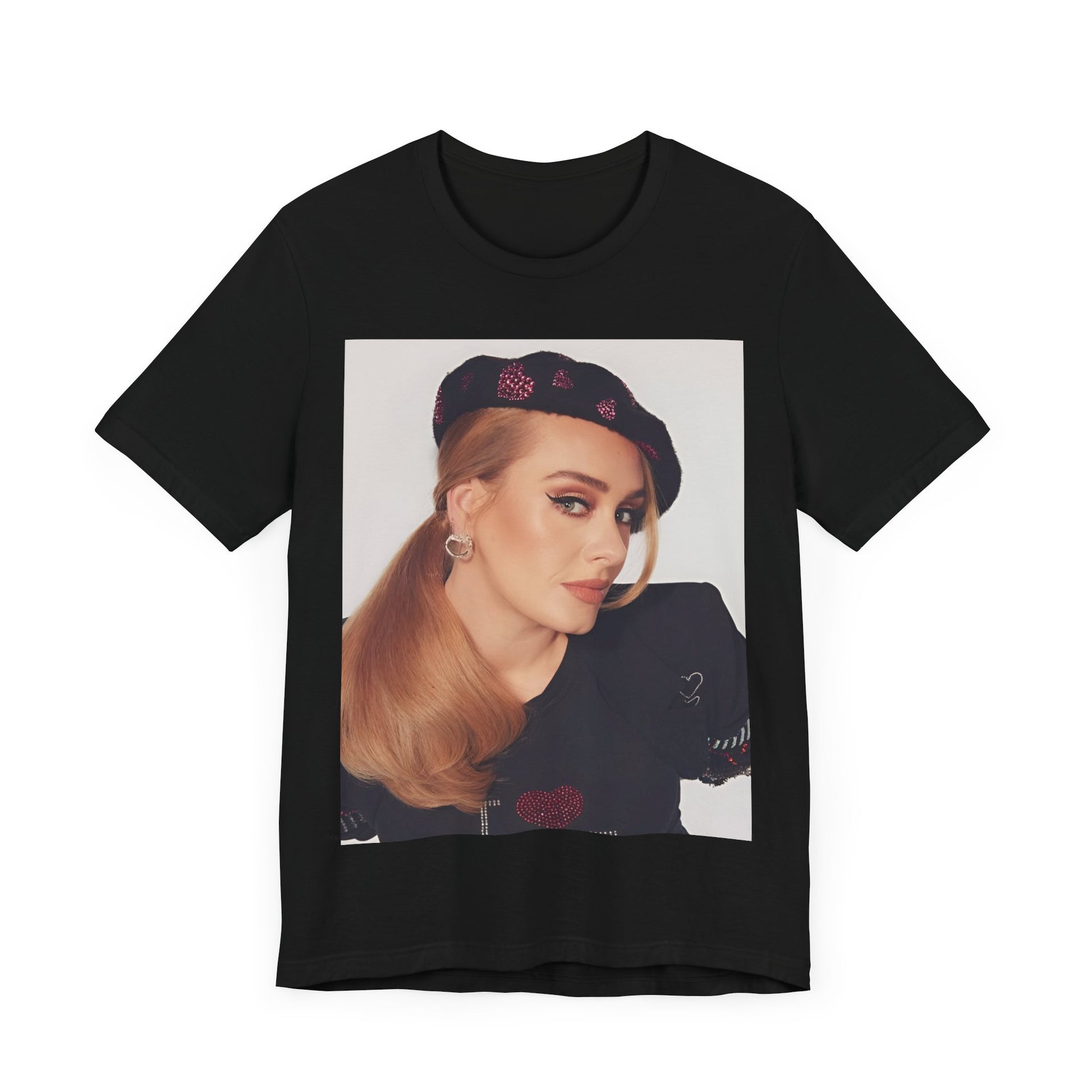 A black graphic t-shirt featuring a black and white photo of Adele wearing a heart-shaped beret, with a gentle or smiling expression.