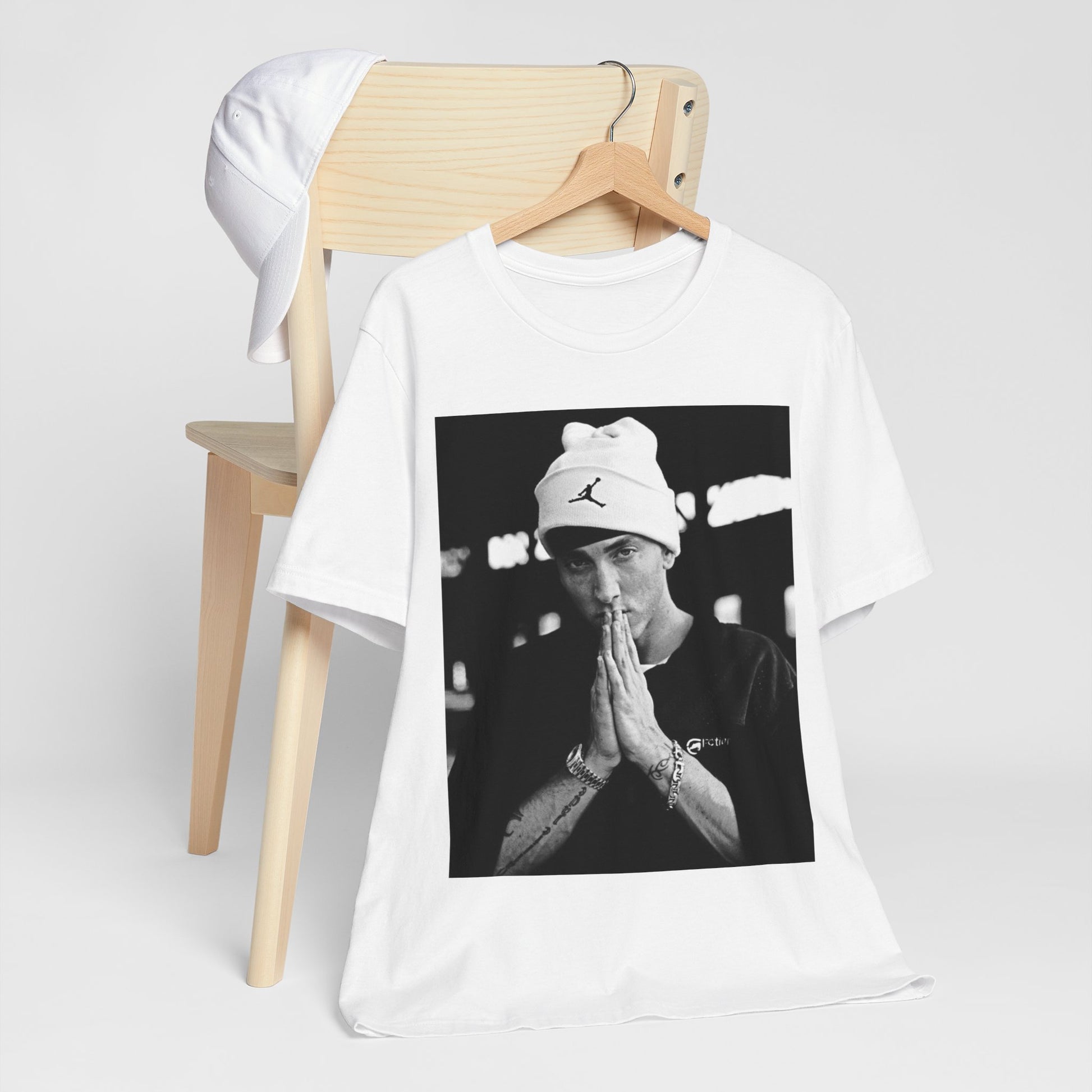 A black graphic t-shirt featuring a black and white portrait photo of Eminem.
