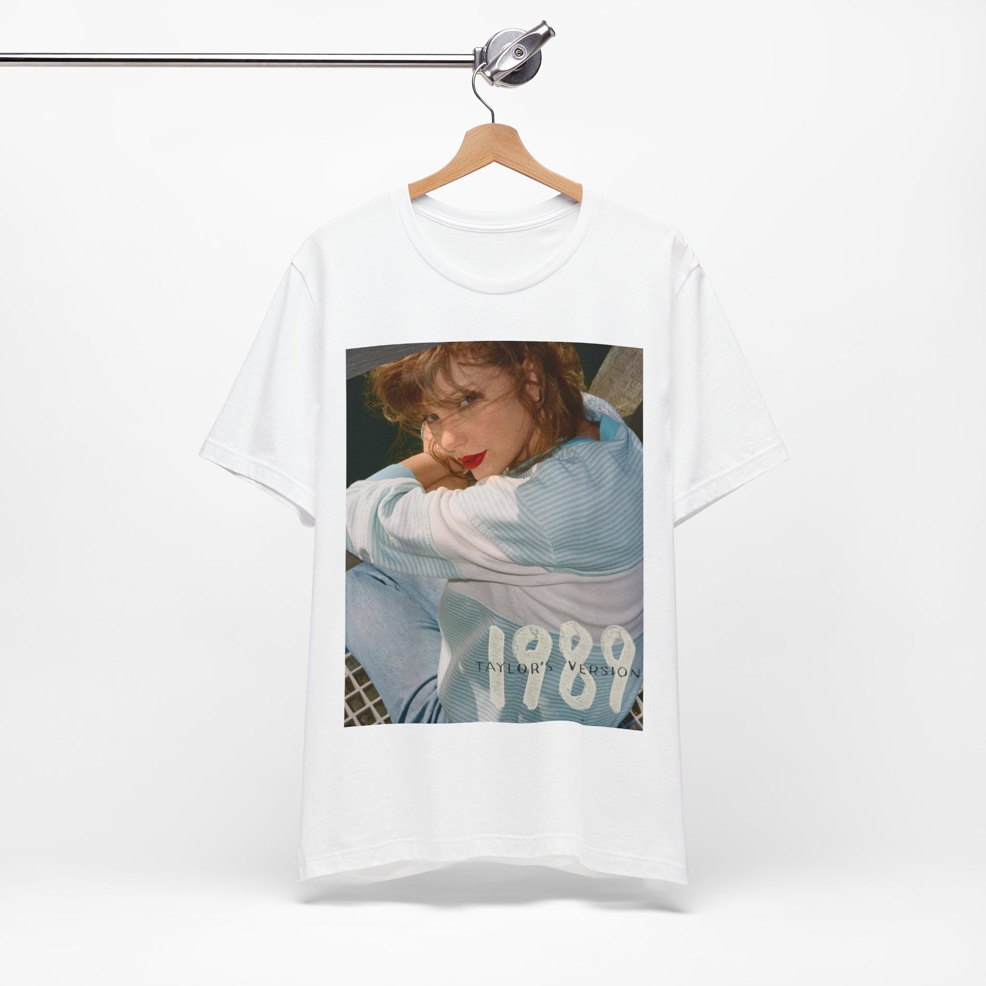 A black graphic t-shirt featuring a 1989 aesthetic graphic of Taylor Swift.