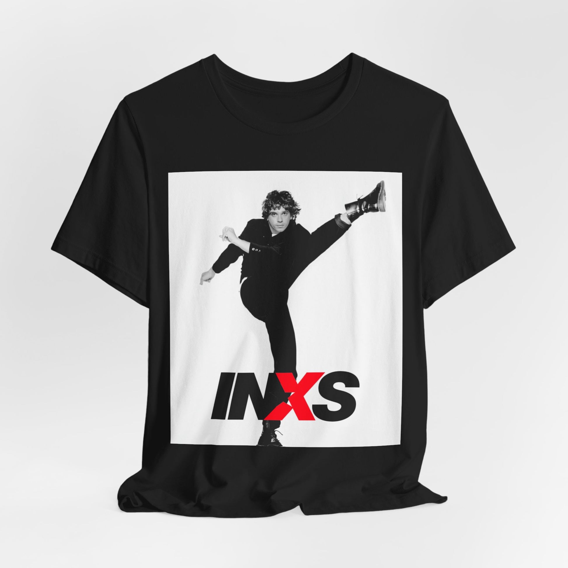A black graphic t-shirt featuring a retro graphic related to INXS's 'Kick' album era.