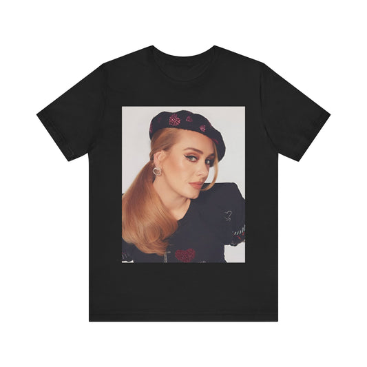 A black graphic t-shirt featuring a black and white photo of Adele wearing a heart-shaped beret, with a gentle or smiling expression.