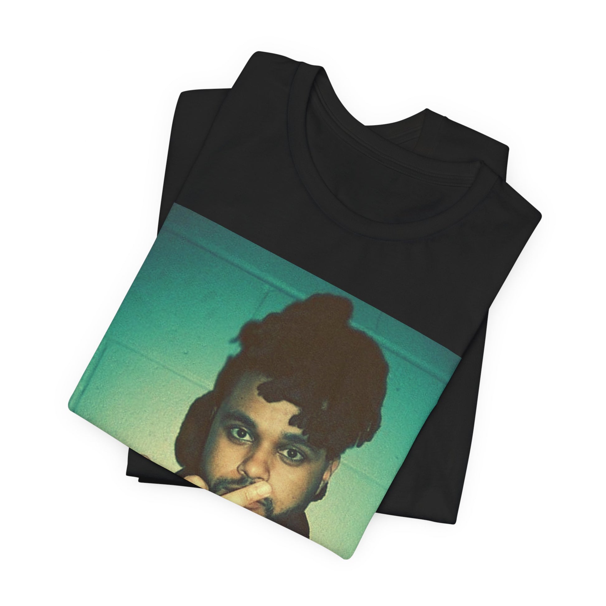 A black graphic t-shirt featuring a graphic of The Weeknd making the middle finger gesture.