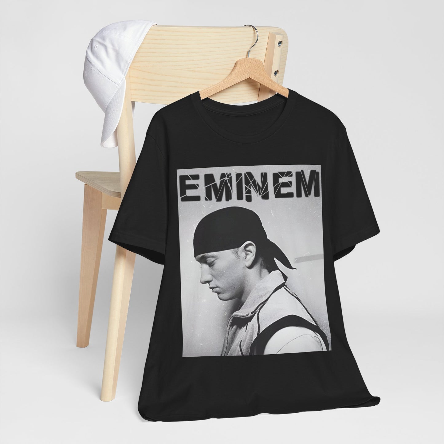 A black graphic t-shirt featuring a stylized graphic of Eminem as a modern rap legend.