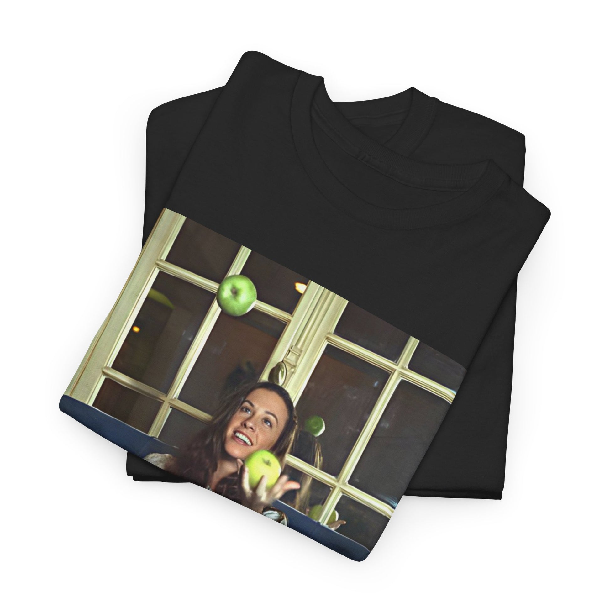 A black graphic t-shirt featuring a candid photo of Alanis Morissette sitting on a couch, looking relaxed or thoughtful.