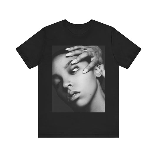 A black graphic t-shirt featuring a black and white, monochrome graphic or photo of Tinashe.