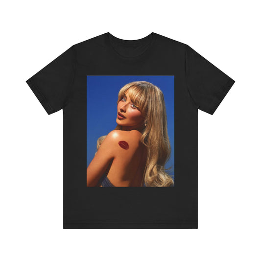 A black graphic t-shirt featuring a stylized graphic of Sabrina Carpenter, designed with a modern pop aesthetic.