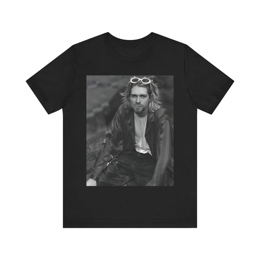 A black graphic t-shirt featuring a 90s black and white photo portrait of Kurt Cobain from Nirvana.