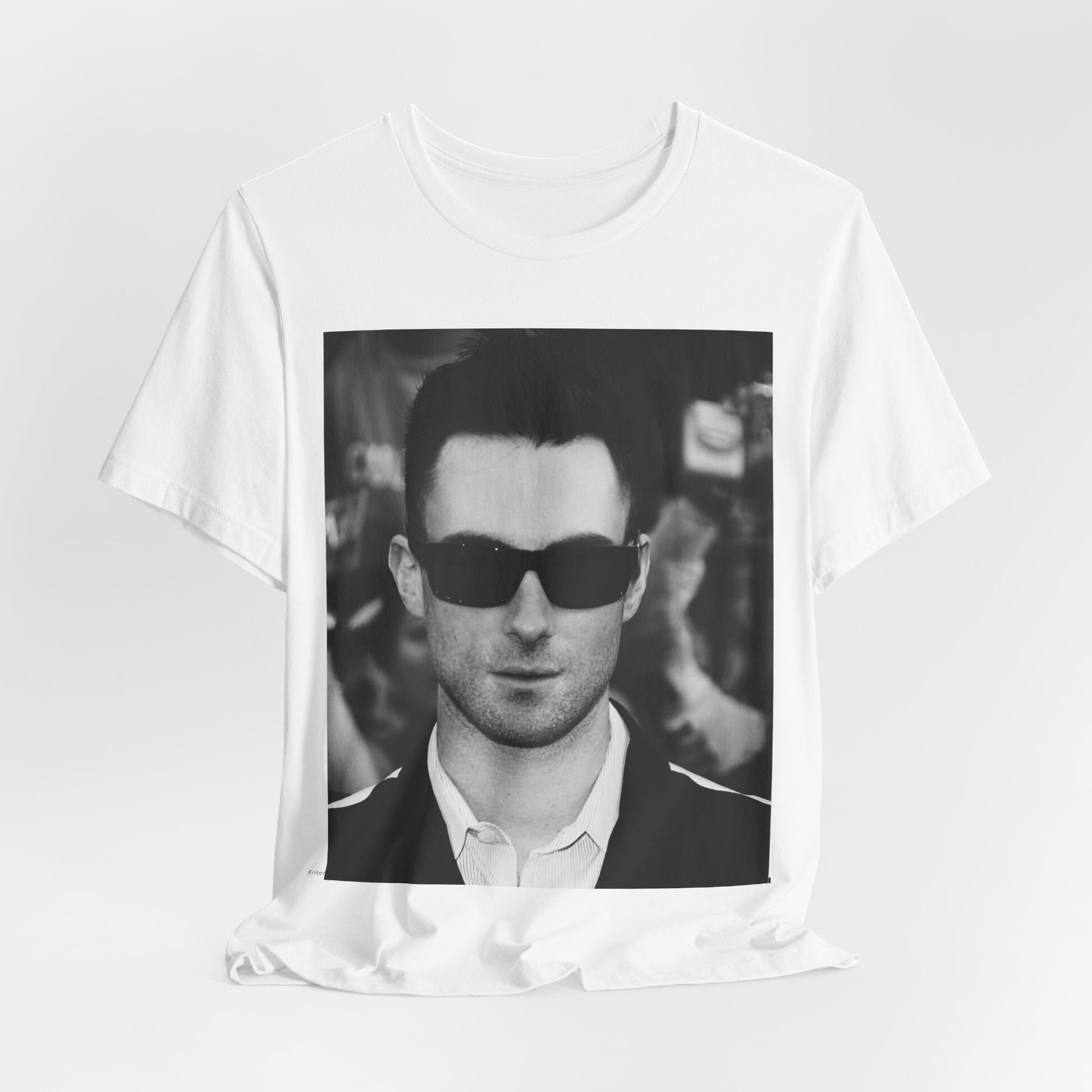 A black and white high-fashion photoshoot photo of Adam Levine, frontman of Maroon 5, looking confidently at the camera.