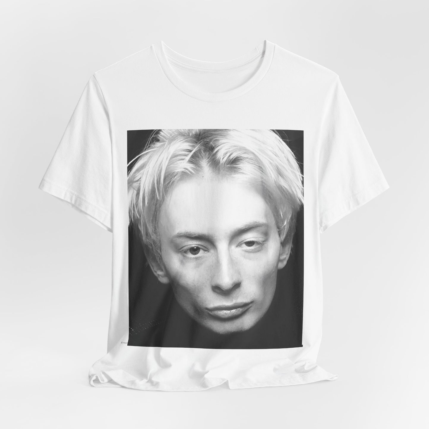 A black graphic t-shirt featuring a 90s black and white portrait photo of Thom Yorke from Radiohead.