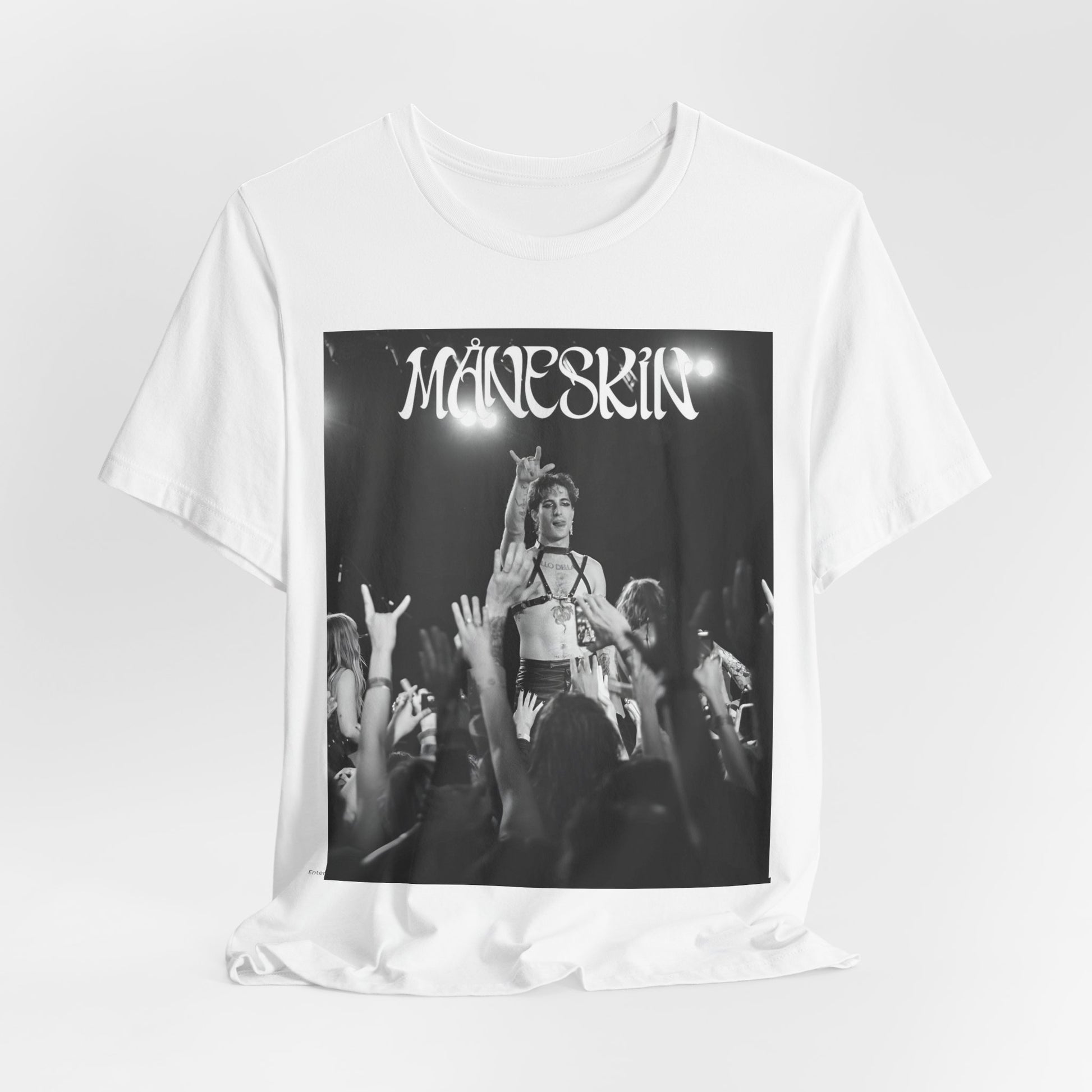A black graphic t-shirt featuring a graphic or photo of Maneskin performing live.
