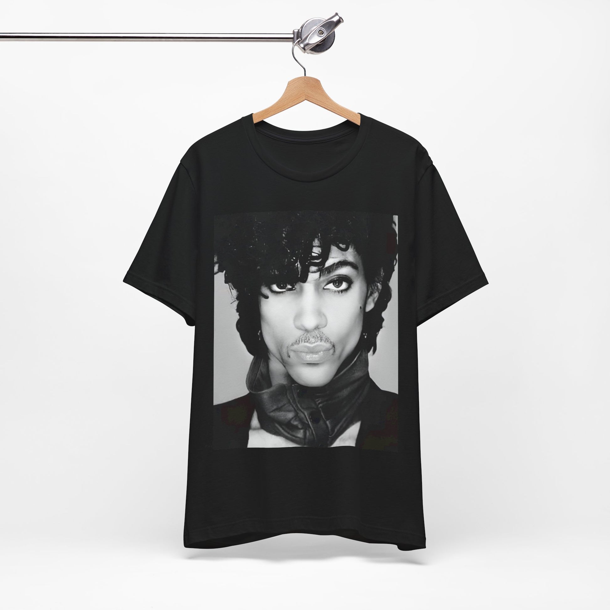 A black graphic t-shirt featuring a black and white photo portrait of Prince.