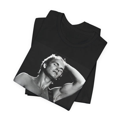 A black graphic t-shirt featuring a graphic or photo of Sting performing live on stage in 1983.
