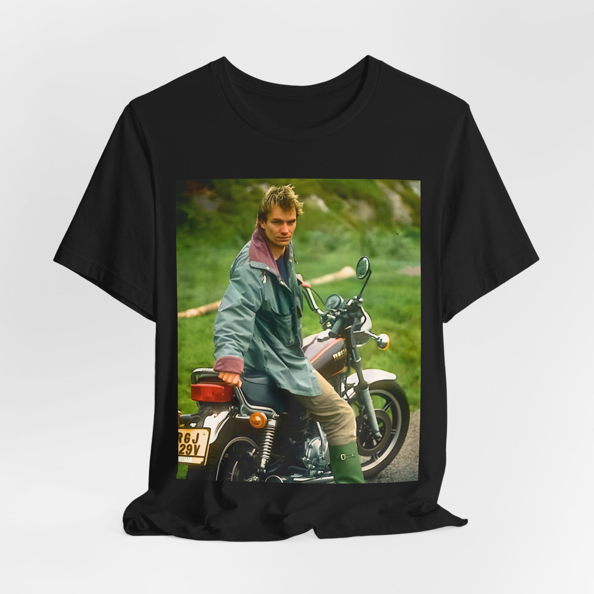 A black graphic t-shirt featuring a graphic of Sting from The Police with a motorcycle theme.