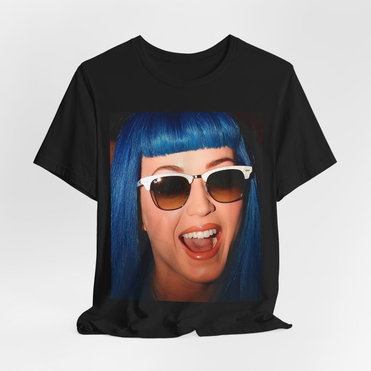 A black graphic t-shirt featuring a retro graphic of Katy Perry with blue hair.