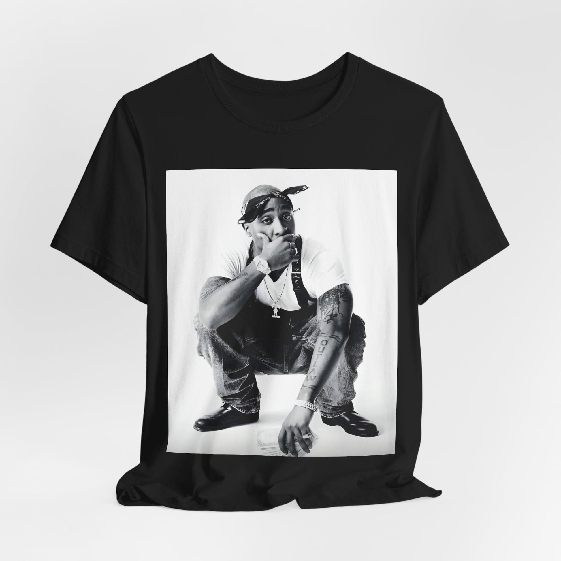 A black graphic t-shirt featuring a graphic of Tupac with a conscious rap vibe.